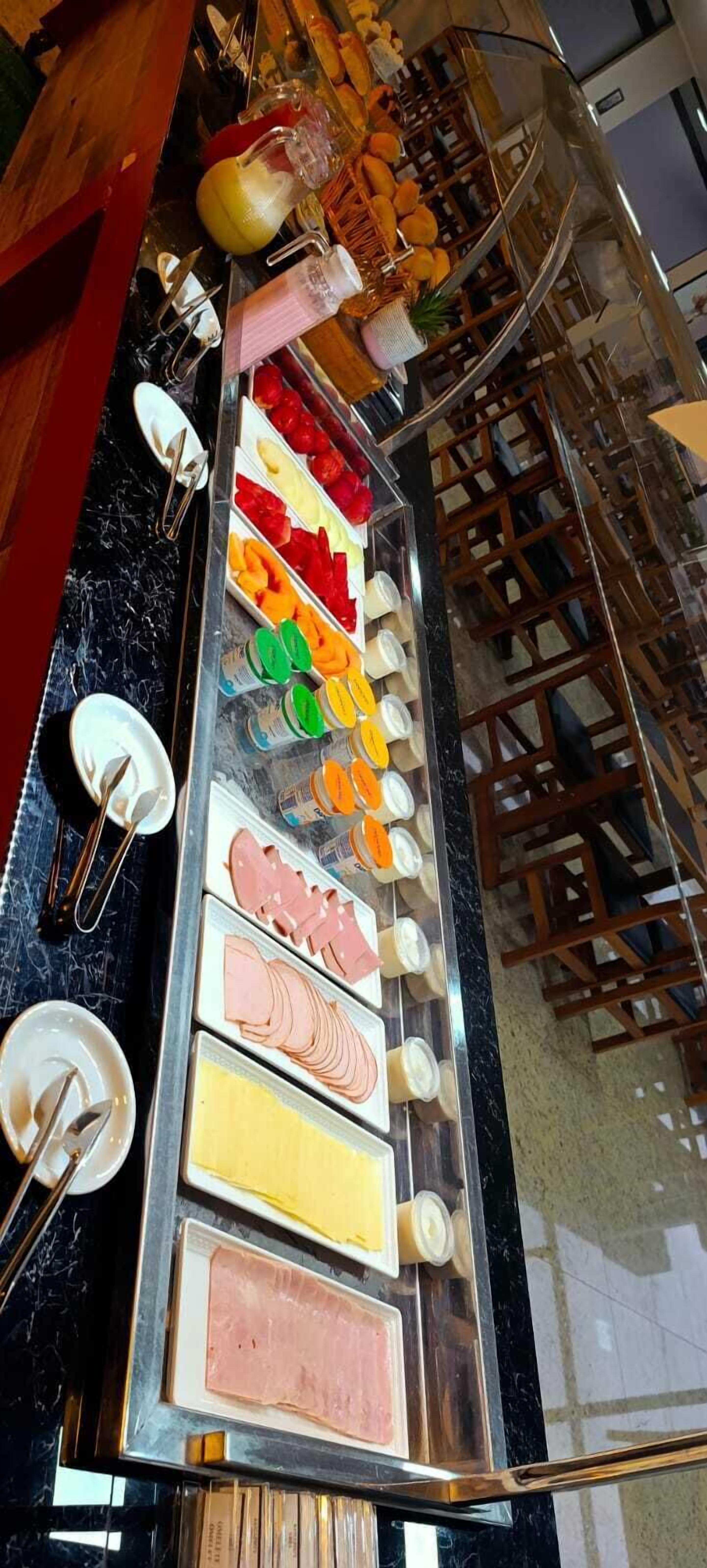 A buffet with various food items and condiments.
