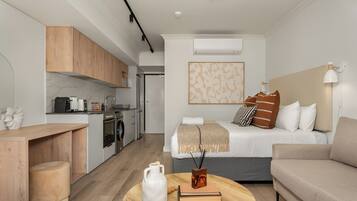 A modern apartment with a kitchen, a dining area, a living room, and a bedroom.