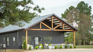 Un bâtiment moderne doté d’un porche abrité, d’une grande fenêtre et d’une pelouse bien entretenue.