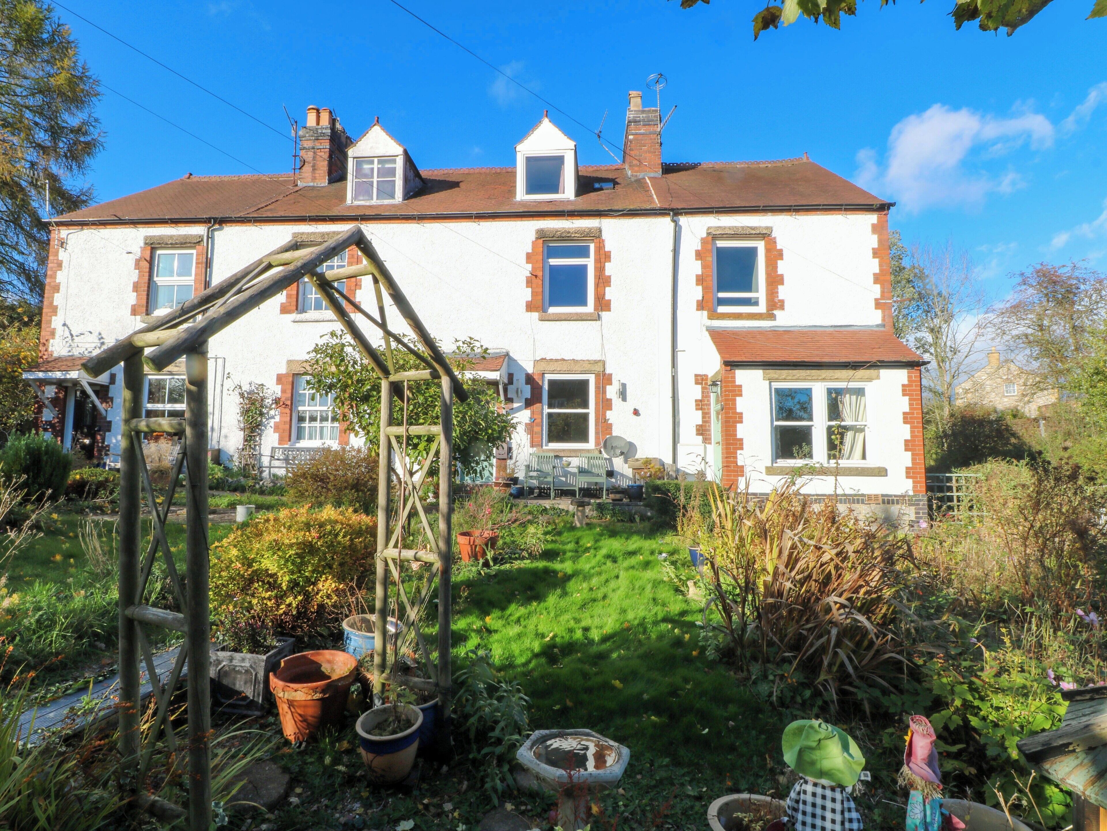 A two-story house with a garden in front.