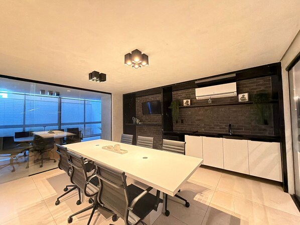 A modern kitchen with a white countertop, black cabinets, and a built-in oven.