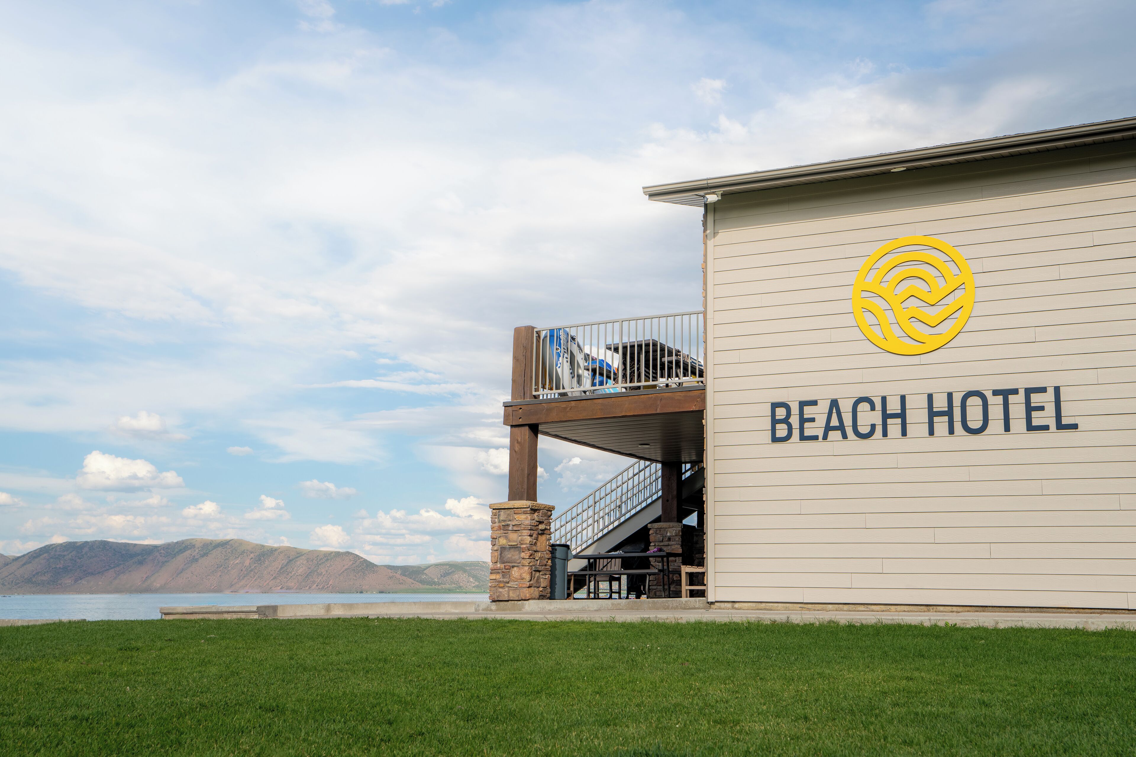 A beach hotel with a view of the water and mountains.