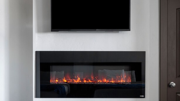 A modern living room with a flat-screen TV mounted above a fireplace. - Sun Outdoors Garden City Utah (Garden City)