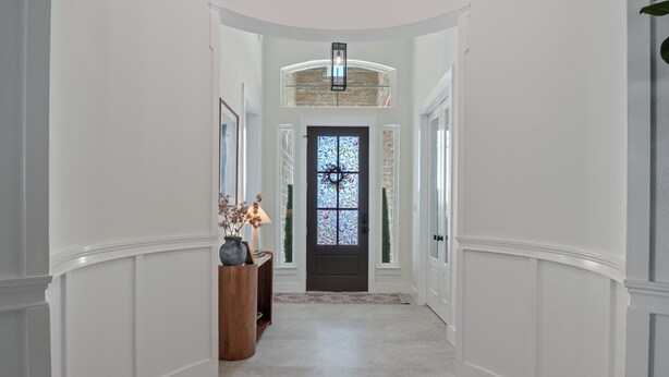 A hallway with a dark door, white walls, and a light fixture above. - Charming 4-bedroom Retreat Near Baylor Hospital & VA Hospital (Temple)