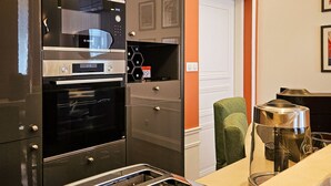 A kitchen with a built-in oven, a toaster, and a coffee maker.