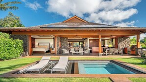A modern house with a swimming pool, a stone exterior, and a covered patio area. - Ocean Views | Resort Amenities | Plunge Pool & Guesthouse (Koloa)