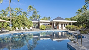 A swimming pool with lounge chairs and palm trees. - *CoralTree Managed* Ground Floor Ocean & Golf Views - Mauna Lani Point A107 (Kamuela)