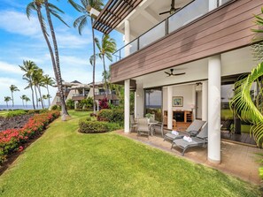 A modern resort with a covered outdoor seating area, a pool, and a view of the ocean. - *CoralTree Managed* Ground Floor Ocean & Golf Views - Mauna Lani Point G101 (Kamuela)