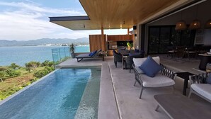 A modern outdoor living area with a pool, seating, and a view of the sea. - Iyari Luxury Villa: 4BR, Private Pool & Premier Access (Punta Mita)