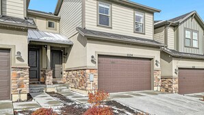 A two-story house with a garage, stone accents, and a well-maintained front yard. - Wasatch Lodge (Heber City)