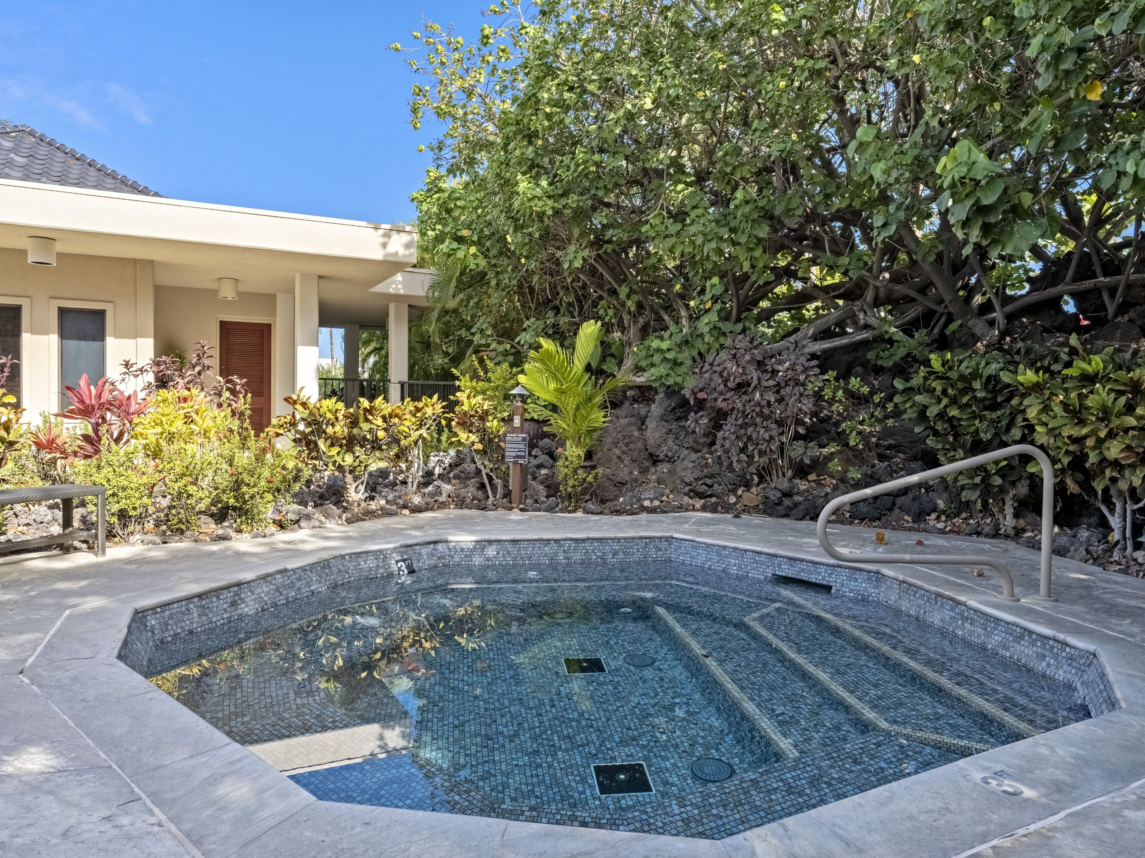 Give your muscles a relaxing soak in the hot tub surrounded by tropical landscaping.
