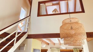 A high-ceilinged room with exposed wooden beams, a staircase, and a rattan hanging light fixture. - Casa Fresno country lodging for up to 5 people near Salamanca (ALMENARA DE TORMES)