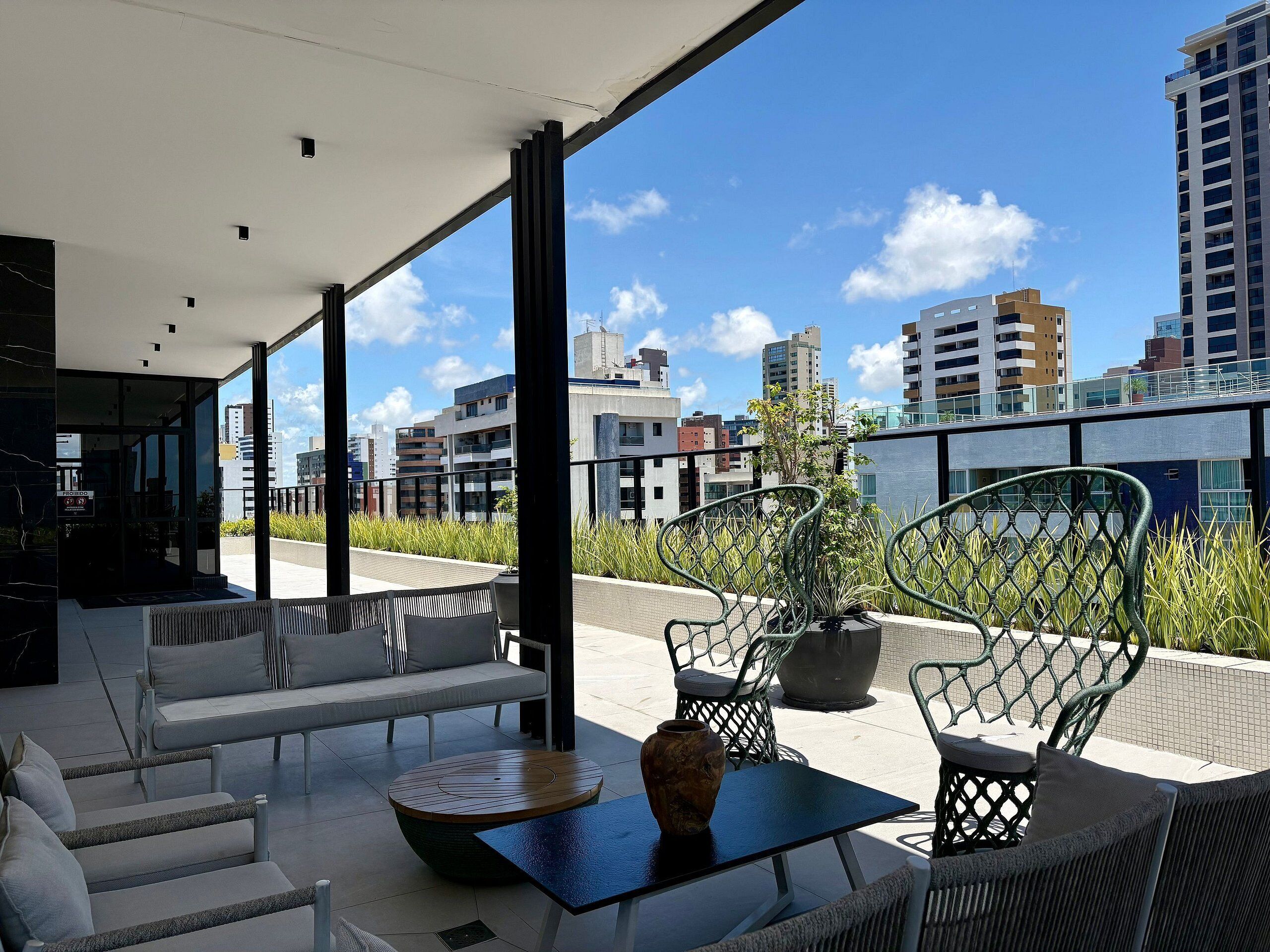 A modern outdoor seating area with a view of the city skyline.