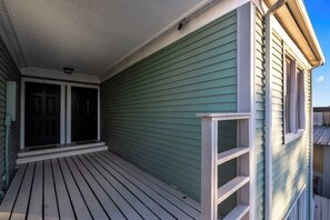 A house with a covered porch, a front door, and a window.
