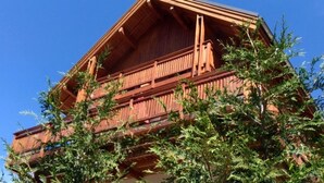 A wooden building with balconies and a clear sky.