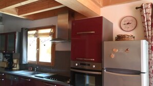 A kitchen with a stove, oven, and refrigerator.