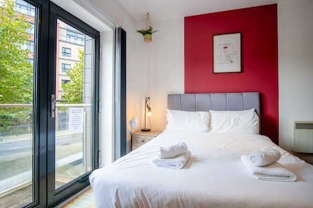 Tabla de planchar con plancha y ropa de cama