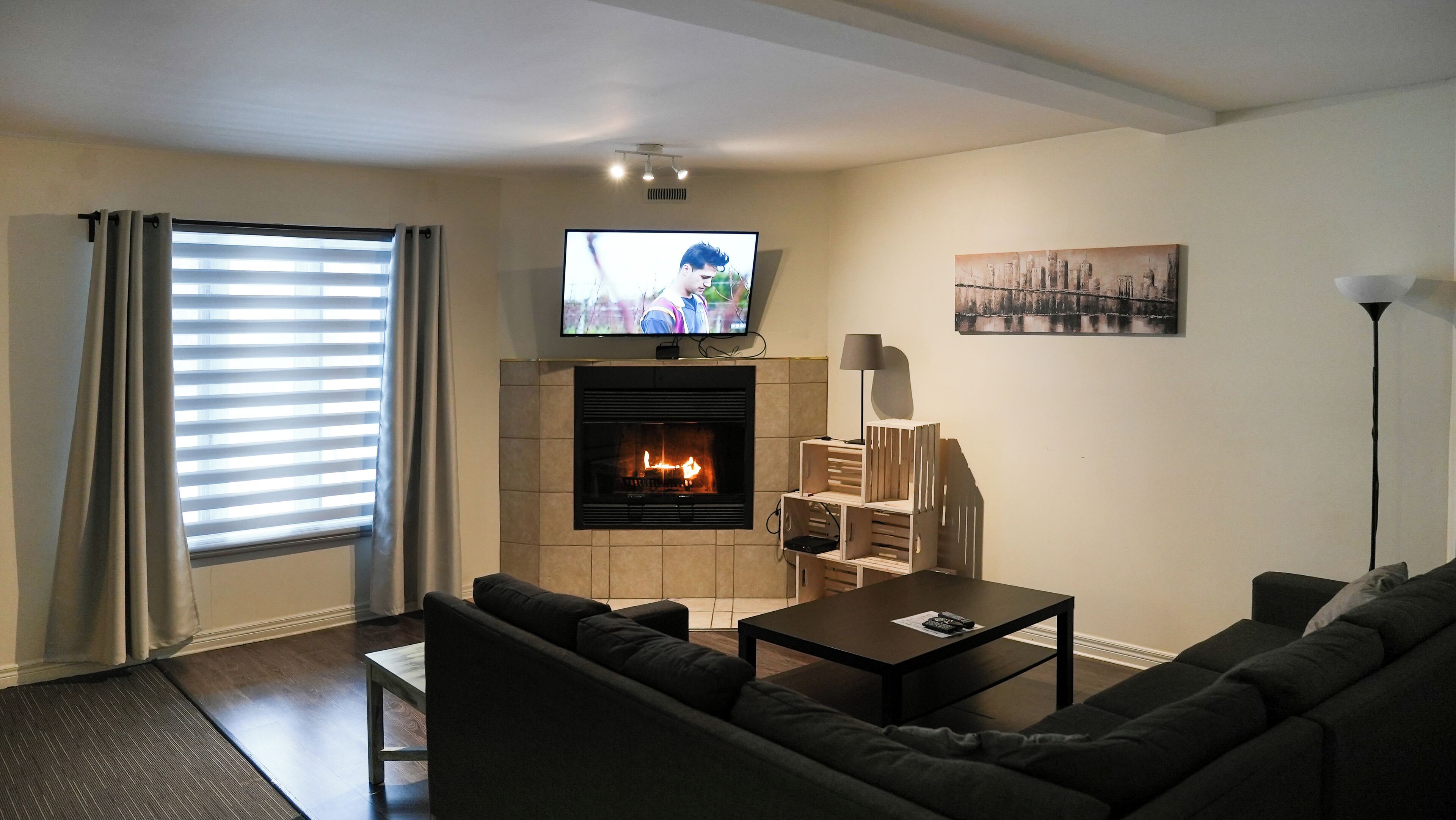 A living room with a fireplace, a television, and a sofa.