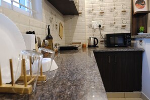 Fridge, microwave, electric kettle, cookware/dishes/utensils