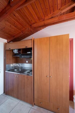 Habitación doble, vistas al patio | Cocina privada | Frigorífico pequeño, placa de cocina y utensilios de cocina