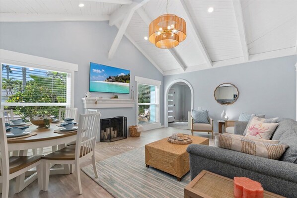 A spacious living area with a fireplace, a television, and a comfortable seating arrangement.