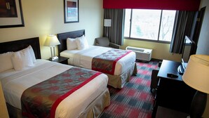 A hotel room with two beds, a desk, a chair, a lamp, and a window with curtains. - Albany Retreat- Free Breakfast & Parking Included (Albany)