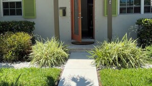 A two-story house with a front door, green shutters, and a number '1728' on the wall. - Serendipity South: Premium Key West Pool Oasis Near The Beach (Key West)