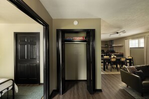A compact living space with a kitchenette, a dining area, and a seating area.