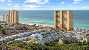 A coastal resort area with high-rise hotels, beachfront, and a pool complex. - Gulf Walk by Avantstay West End Coastal Escape Renovated 1BR Condo Shared Pool & Beach Access (Panama City Beach)