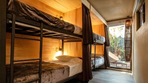 A bunk bed room with wooden walls and a window. - LA SELVA HOSTEL (Mexico City)