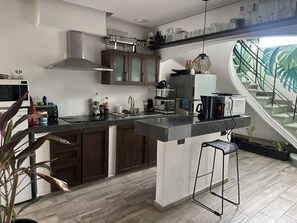 Full-size fridge, microwave, stovetop, cookware/dishes/utensils