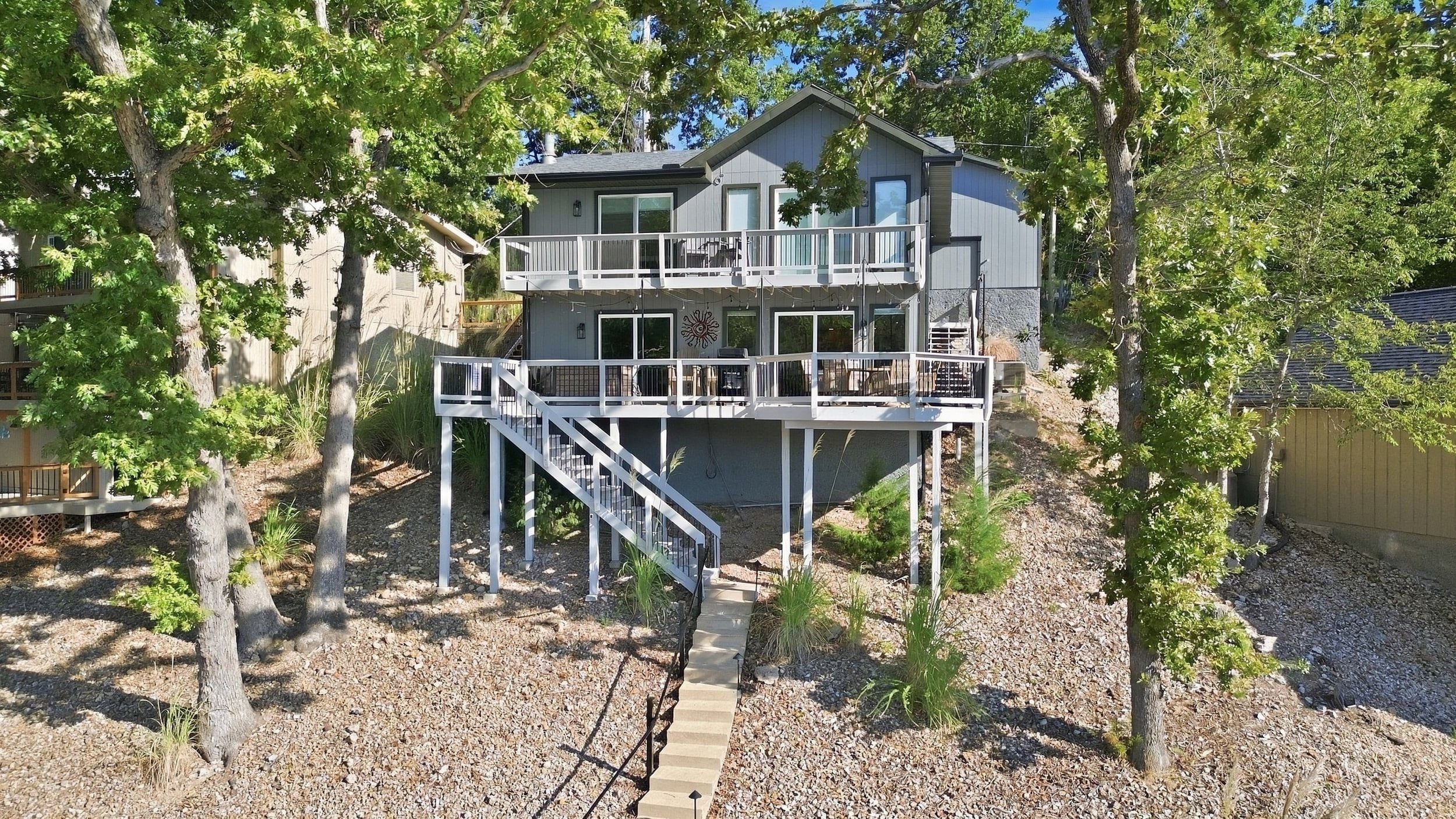 A two-story house with a balcony, a staircase, and a deck area.