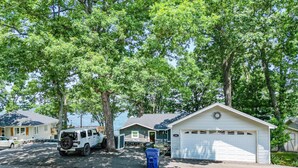 A residential area with a white garage, a white truck, and a mailbox. - Unforgettable Views & Lakefront Firepit Nights (Sunrise Beach)