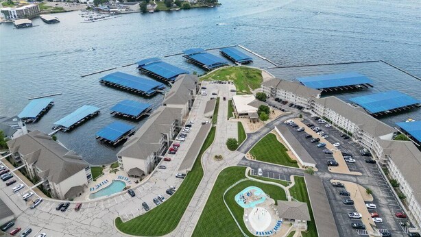 An aerial view of a waterfront hotel with multiple buildings, a swimming pool, and a marina. - Nautical-inspired Lakefront Unit w/ Awesome Views (Osage Beach)