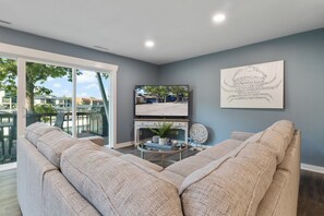 Condo, Multiple Beds, Patio (Castaway Cove Unit 5) | Living area - Walk to The Strip! Great Cove Water for Lake Fun (Lake Ozark)