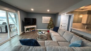 Condo, Multiple Beds, Patio (Castaway Cove Unit 5) | Living area - Walk to The Strip! Great Cove Water for Lake Fun (Lake Ozark)