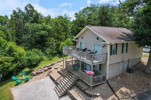A two-story house with a balcony, outdoor seating, and a fire pit. - Perfect for Bachelor-bachelorettes & Friend Groups! (Osage Beach)