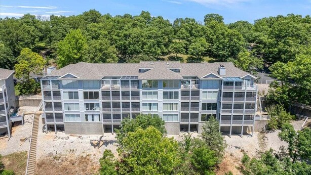 A multi-story hotel with a modern architectural design, featuring balconies and large windows. - Games, Lake Views, Ease of Access to Unit & Attractions, Family-friendly, Outdoor Comfort (Lake Ozark)