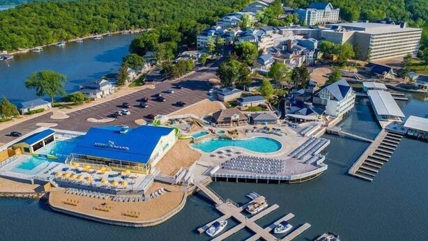 An aerial view of a resort with multiple swimming pools, a marina, and various buildings. - Perfect Resort Retreat Close to Everything (Osage Beach)
