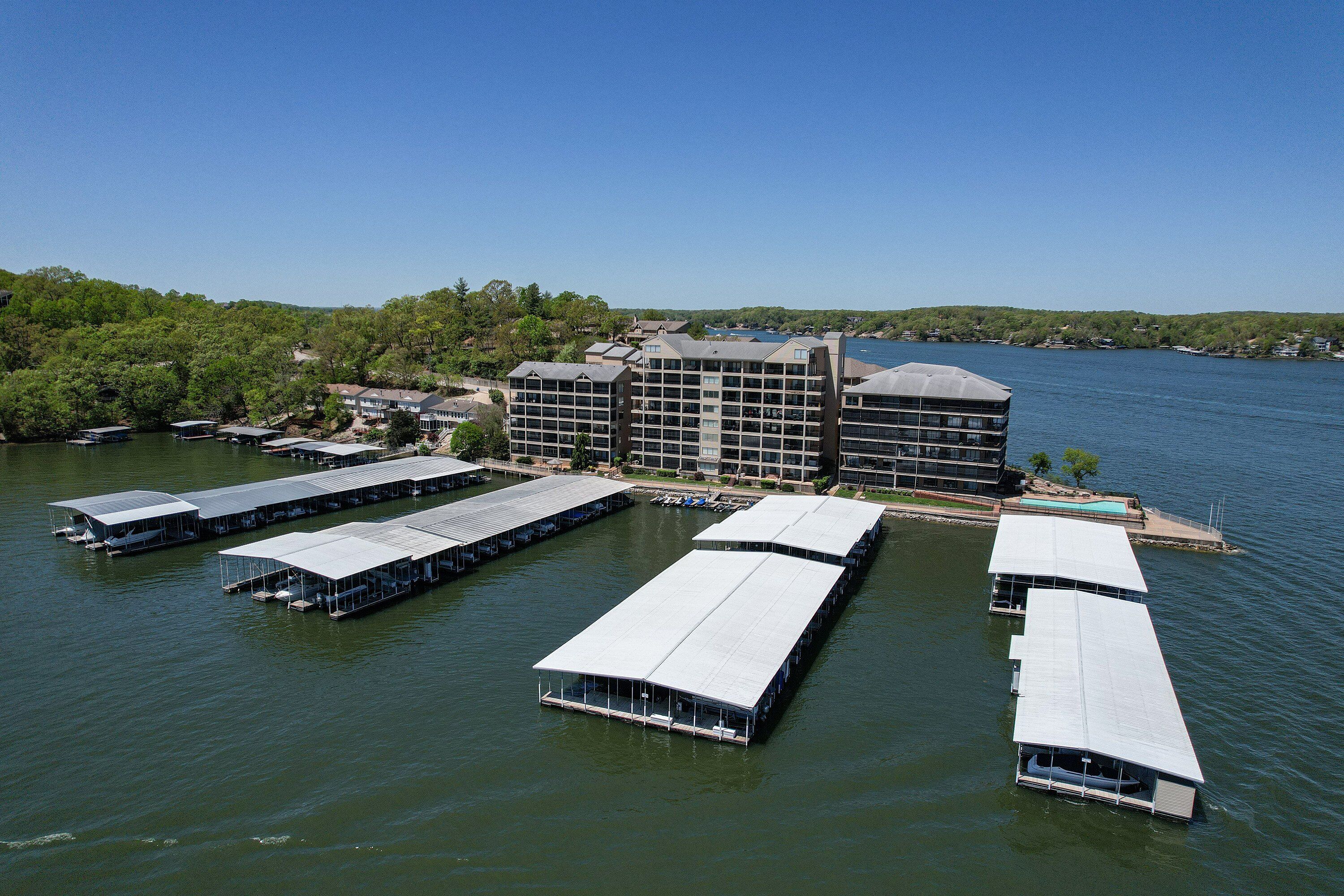 A waterfront hotel with multiple floating structures and a large building with balconies.