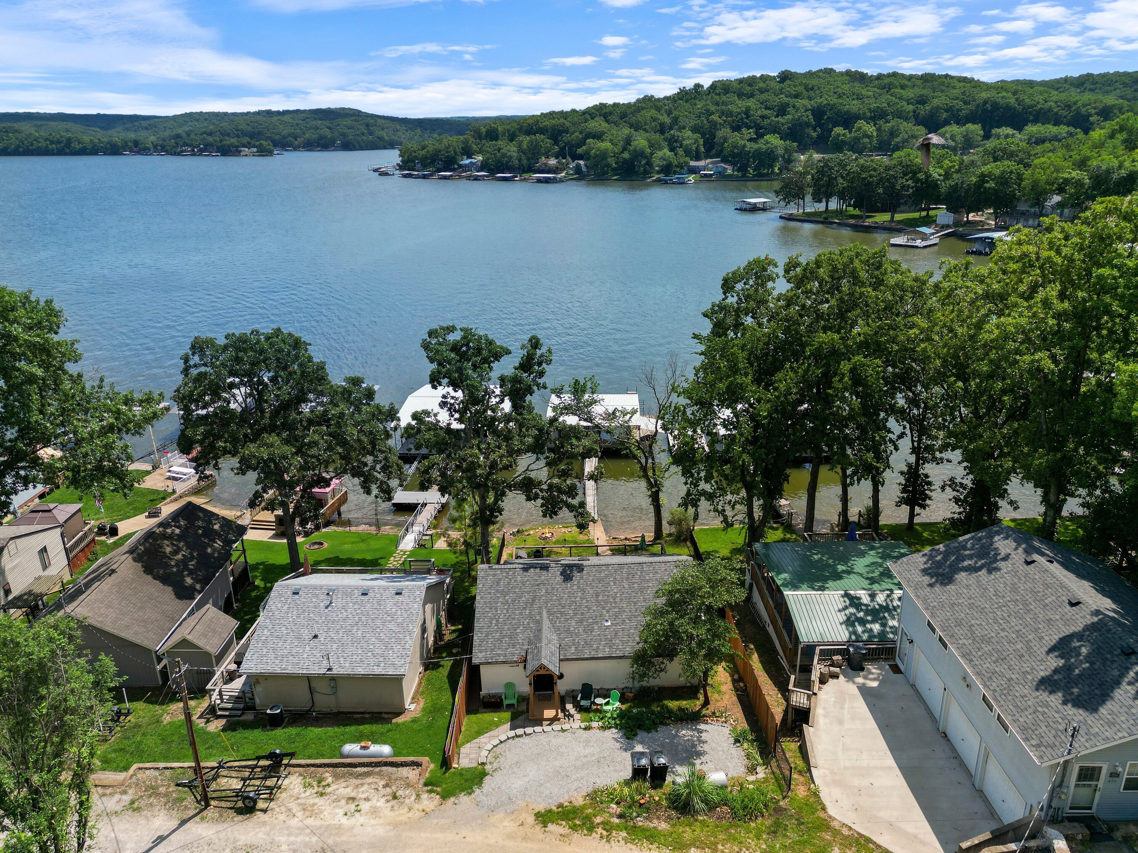A lakeside residential area with houses, a dock, and boats.