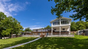 A modern two-story house with a large deck and a staircase leading to the upper level. - Great Location & Lake Views, Boat Slip (Lake Ozark)