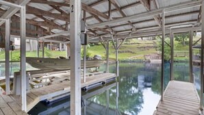 An outdoor swimming pool with wooden decks and a covered area. - Lakefront Escape, Sunrise Views, Boat Slip & Community Dock Access (Roach)