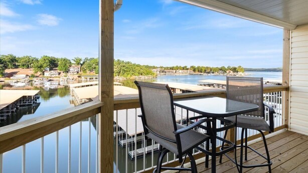 A balcony with a view of a marina and a body of water. - Lakeview Condo w/ 2 Pools & Beach - Family Fun Awaits at 21mm (Osage Beach)