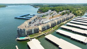A waterfront hotel with multiple buildings, a dock, and a swimming pool. - Lakeview Condo w/ 2 Pools & Beach - Family Fun Awaits at 21mm (Osage Beach)