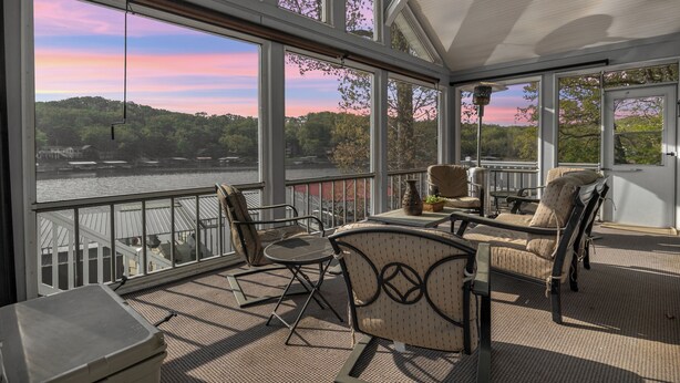 A covered outdoor deck with a view of a lake and trees. - Family-friendly, Dock Enjoyment, Kayaks, Lake View (Sunrise Beach)