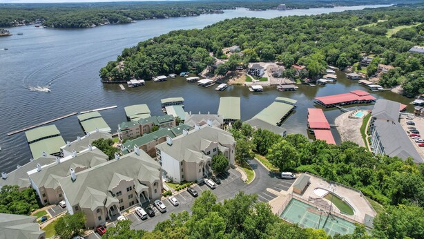 A lakeside hotel with multiple boat docks, a swimming pool, and a tennis court. - Prime Spot, Breathtaking Views, Nearby Attractions (Lake Ozark)