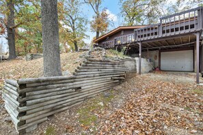 A wooden staircase leading to a house with a garage. - Stunning Lake View On A Nice & Quiet Relaxing Home (Climax Springs)