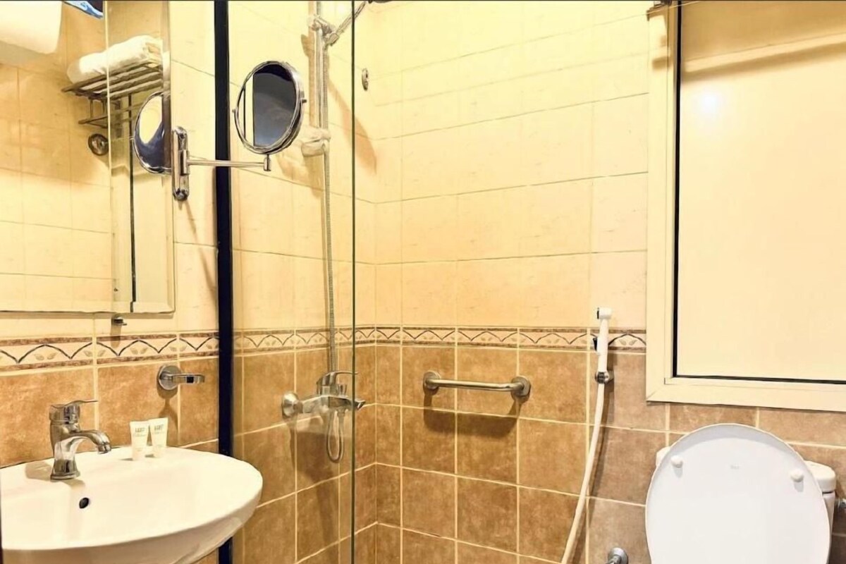 A bathroom with a sink, toilet, and shower.