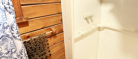 A wooden cabin with a white shower stall.